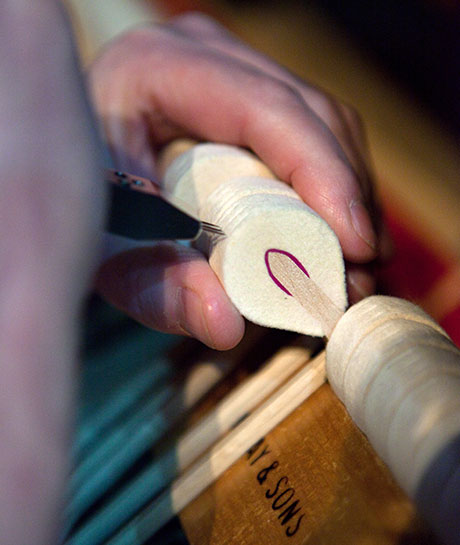 Close-up of Philip Kennedy tuning a piano